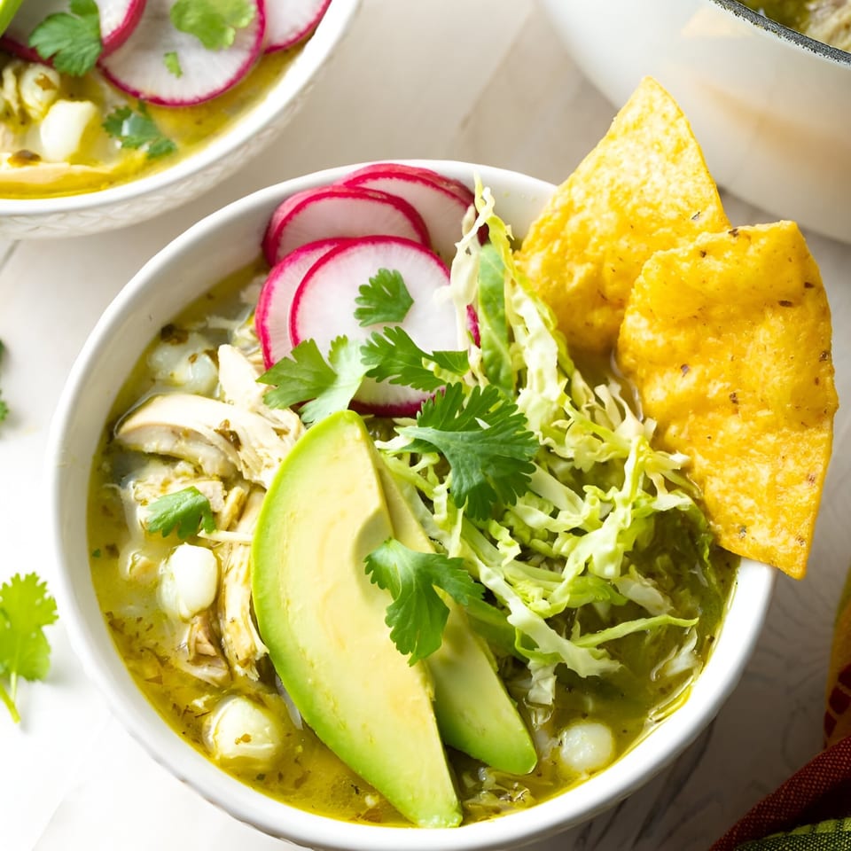 Hops N Guac's pozole verde with chicken, hominy, avocado, radishes, shredded cabbage, and tortilla chips.